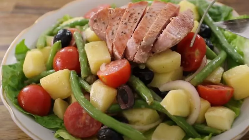 Cắt cá ngừ thành miếng vừa ăn rồi bày lên phần salad